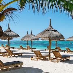 On the beach, white sand, sun-loungers, beach umbrellas