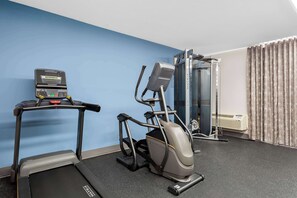 A gym with a treadmill, elliptical, and weight machine. - SureStay Plus by Best Western Windsor (Windsor)