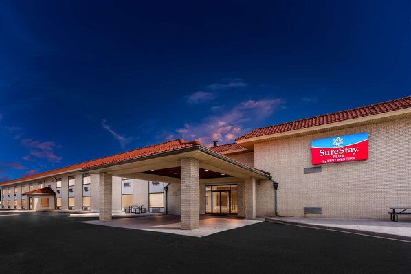 A SureStay Plus hotel with a red-tiled roof, a covered entrance, and a brick facade. - SureStay Plus by Best Western Windsor (Windsor)