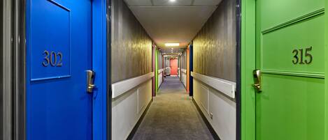 A hotel corridor with doors numbered 302 and 315.