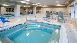 An indoor swimming pool with clear water, a no diving sign, and a lifeguard chair. - AmishView Inn and Suites (Ronks)