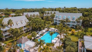A resort with multiple buildings, a swimming pool, and palm trees. - Valentines Resort & Marina (Dunmore Town)