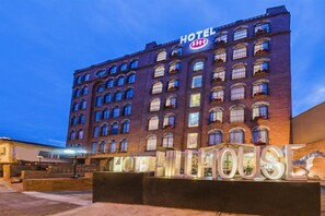 A hotel with a prominent sign reading 'HOTEL' and 'HOTEL HOUSE' in illuminated letters. - Hill house Hotel (Seoul)