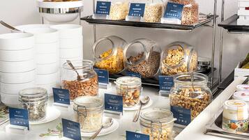 A buffet with various food items in jars and bowls, each labeled with the RHC logo.