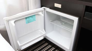 An open refrigerator with a control panel and a note on the door.