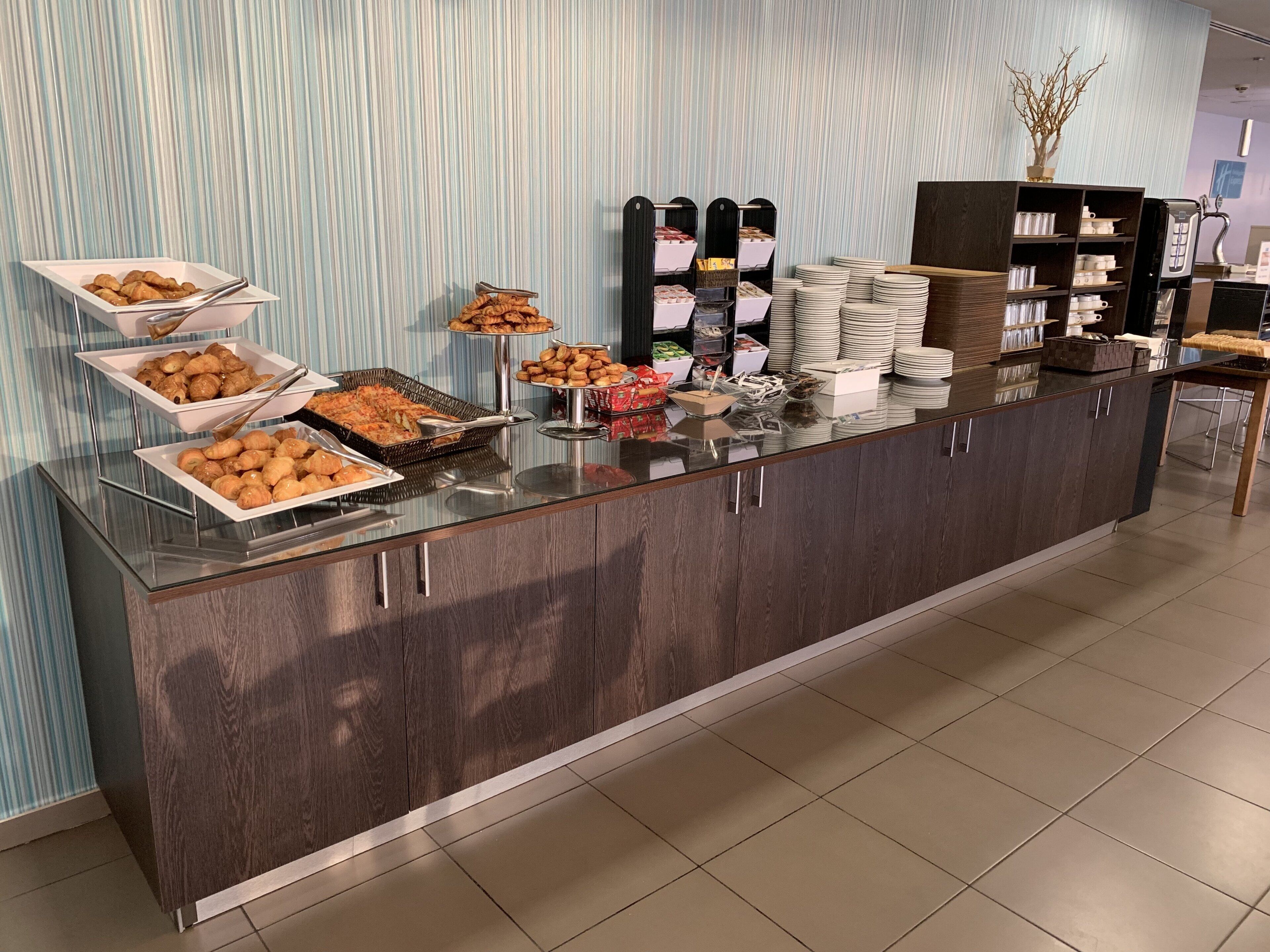A buffet setup with various food items and a beverage station.