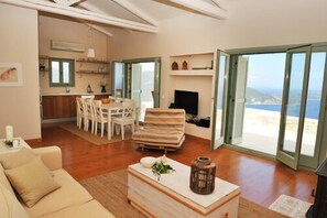 Luxury Villa, Sea View (Helios and Ios) | Living area | 70-cm flat-screen TV with satellite channels, TV, DVD player