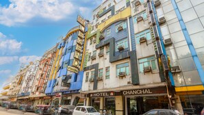 A multi-story building with various shops and a hotel named "HOTEL CHANCHAL" on the ground floor. - Hotel Chanchal Continental (New Delhi)