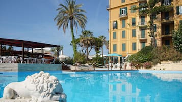Seasonal outdoor pool, open 9:00 AM to 7:00 PM, pool umbrellas