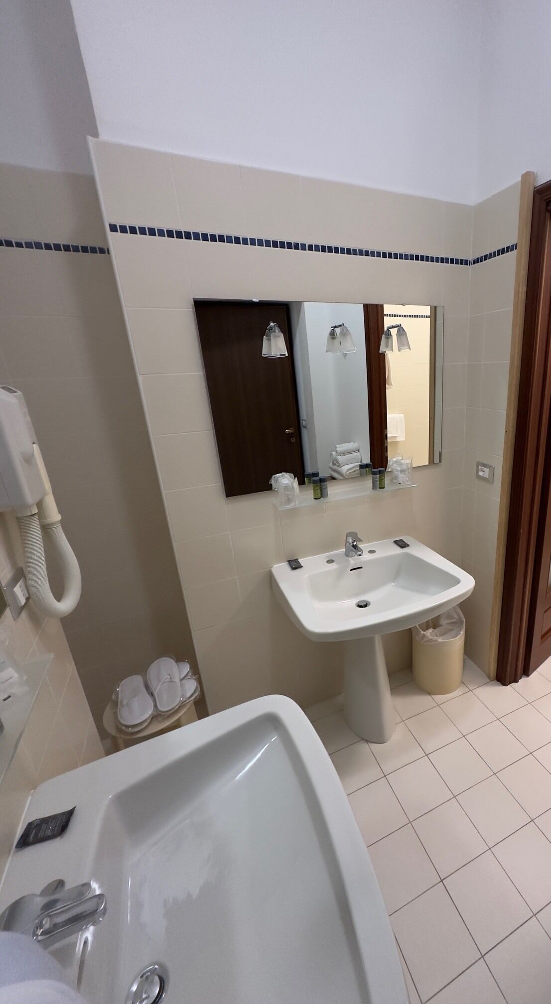 A bathroom with a sink, mirror, and toilet.