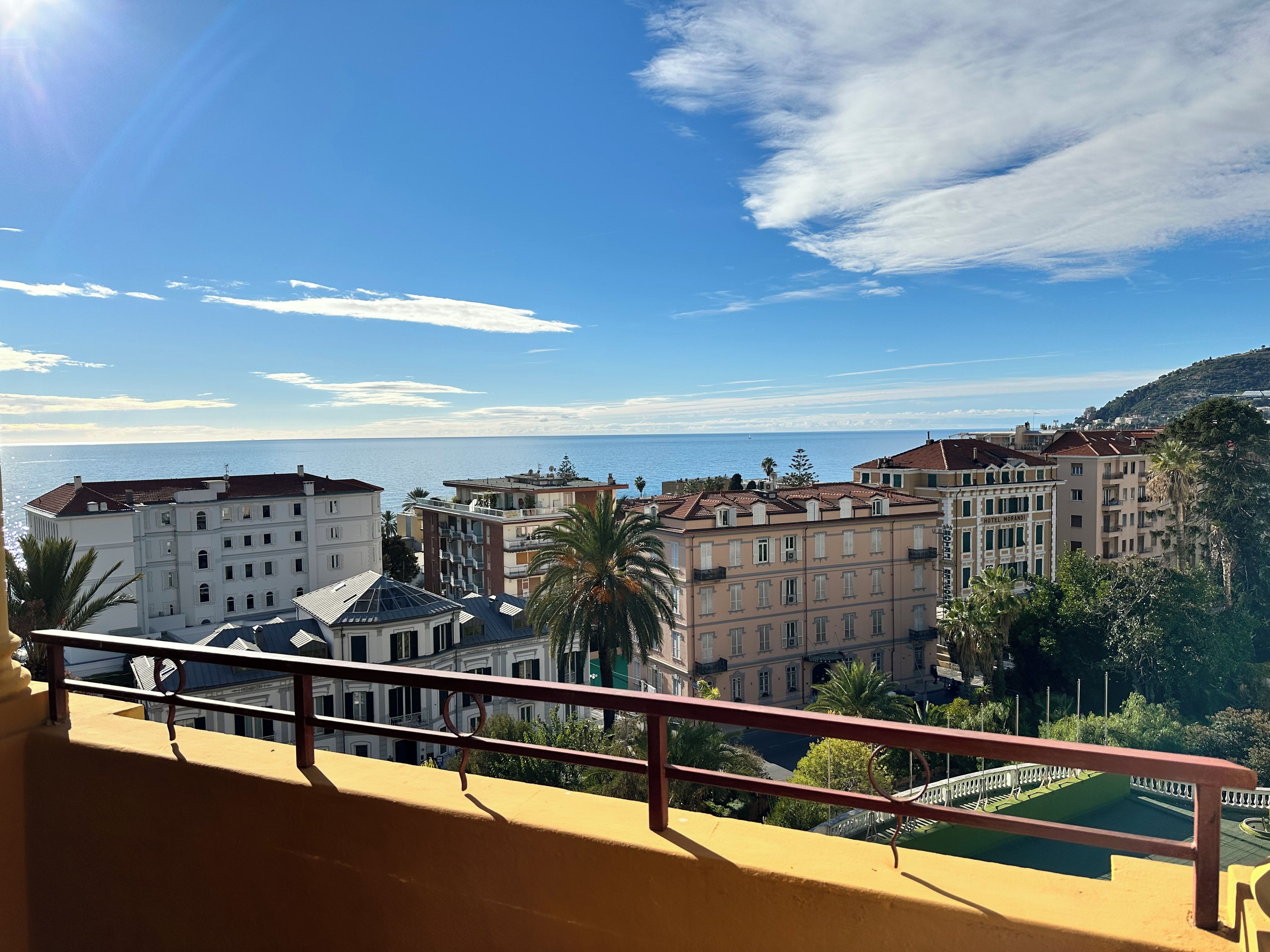 A coastal cityscape with buildings overlooking the sea, including a hotel named "HOTEL MORANDY".