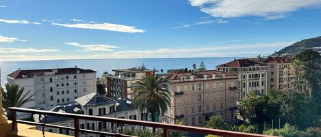 A coastal cityscape with buildings overlooking the sea, including a hotel named "HOTEL MORANDY".