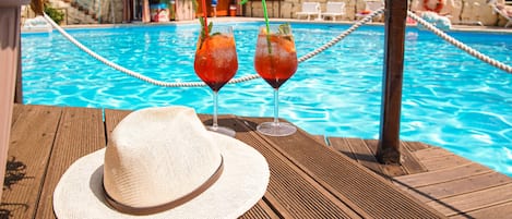 Seasonal outdoor pool, open 9:00 AM to 7:00 PM, pool umbrellas