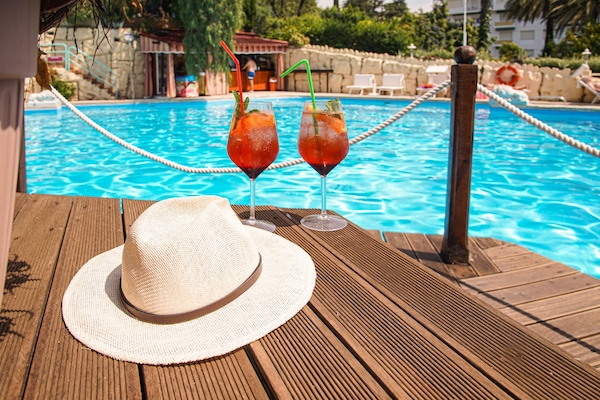 Seasonal outdoor pool, open 9:00 AM to 7:00 PM, pool umbrellas