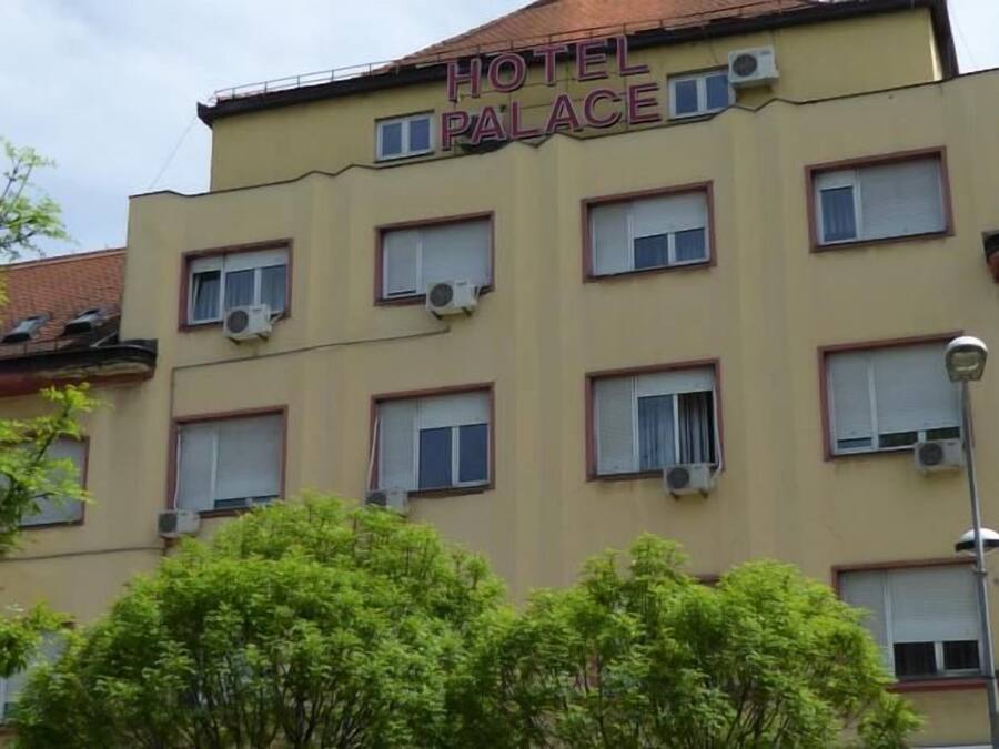 Un edificio de varios pisos con un letrero que dice 'HOTEL PALACE'.