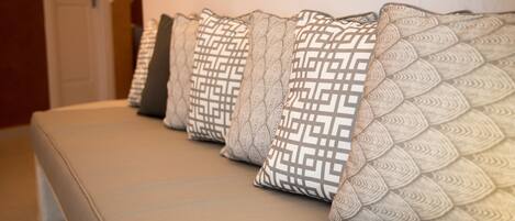 A row of patterned cushions on a sofa.