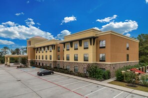 Hotel building with a two-story structure, surrounded by landscaped areas and parking lot.