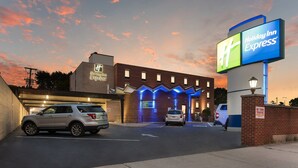 A Holiday Inn Express hotel entrance with a brick facade and illuminated signage. - Holiday Inn Express Columbus Downtown by IHG (Columbus)