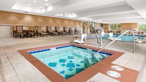 A hotel pool area with a hot tub, lounge chairs, and a seating area. - Hampton Inn & Suites Fairbanks (Fairbanks)