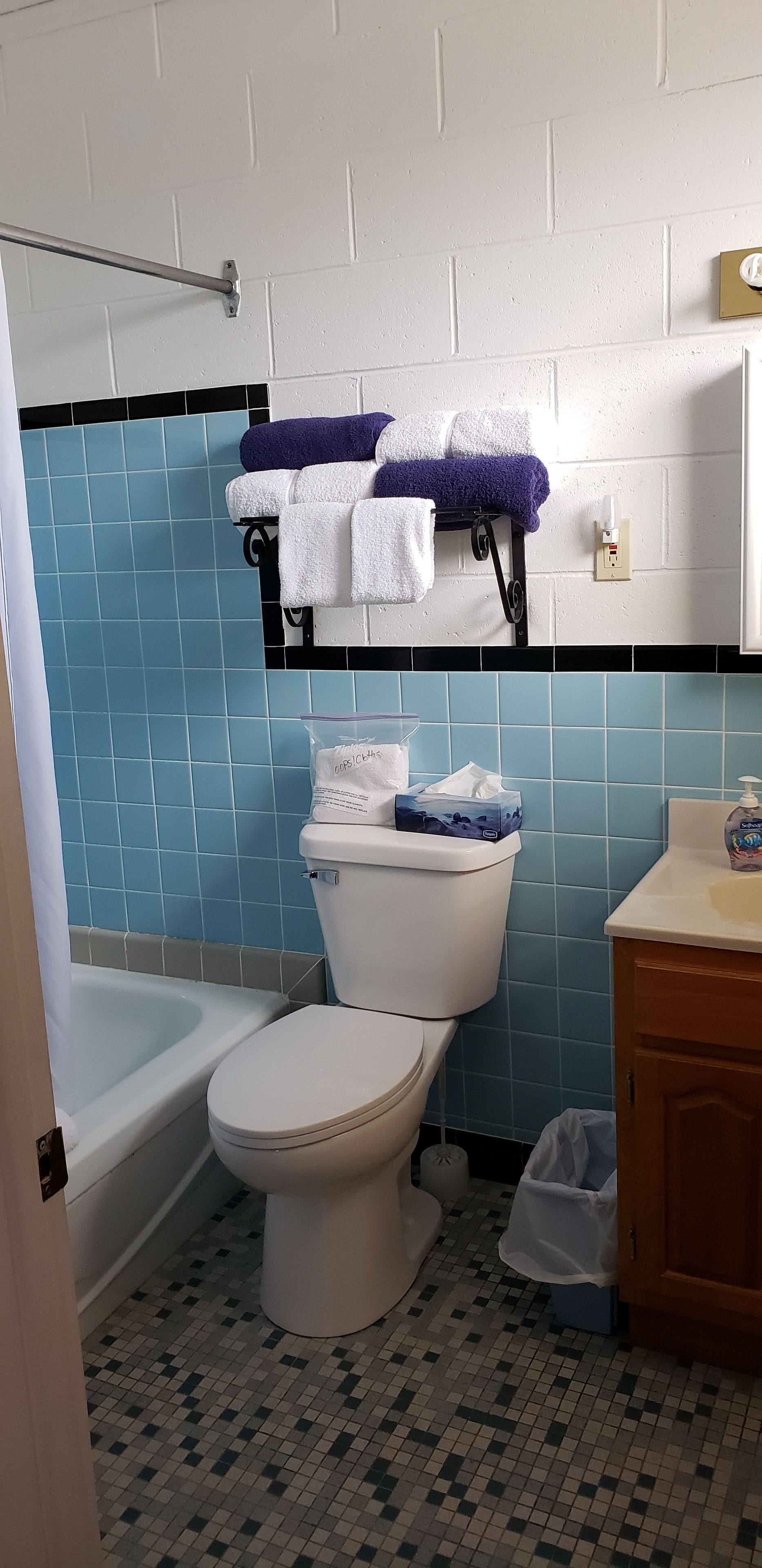 A bathroom with a toilet, a bathtub, and a sink.