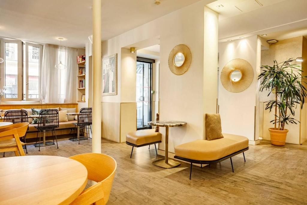 A modern interior with a seating area, a small table, and a potted plant.