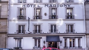 A multi-story building with the sign "HOTEL MARIGNY" prominently displayed. - Hotel Opera Marigny (Paris)