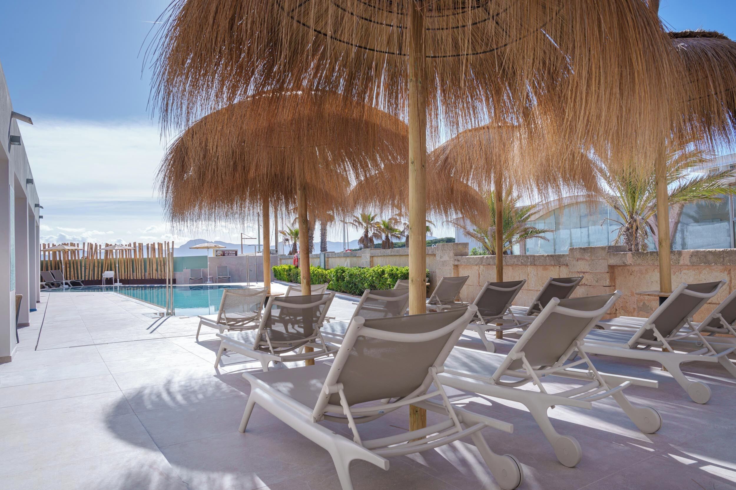 outdoor pool, pool loungers, lifeguards on site