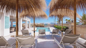 Outdoor pool, pool loungers, lifeguards on site