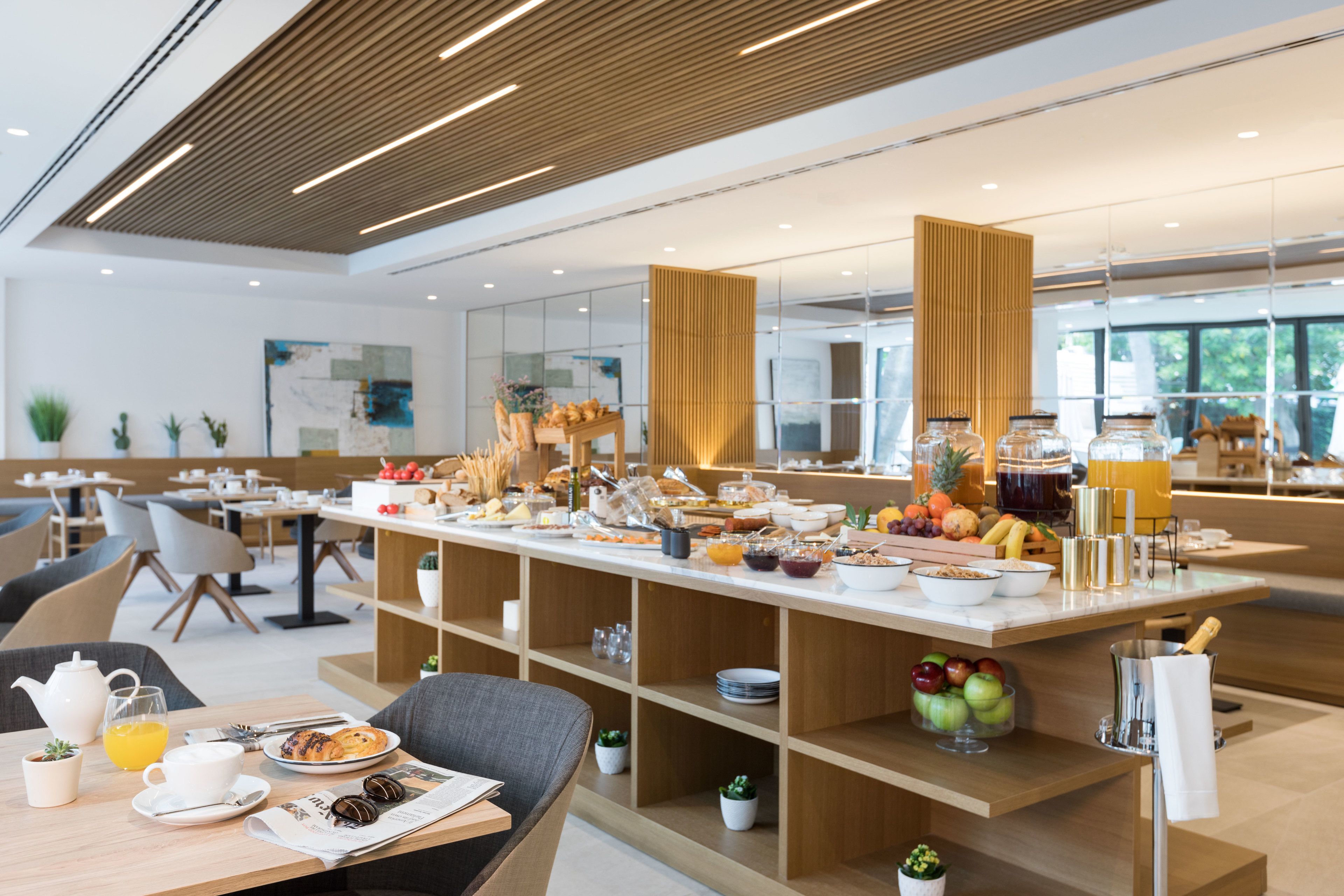 A modern breakfast buffet with a variety of food items and a clean, contemporary interior design.