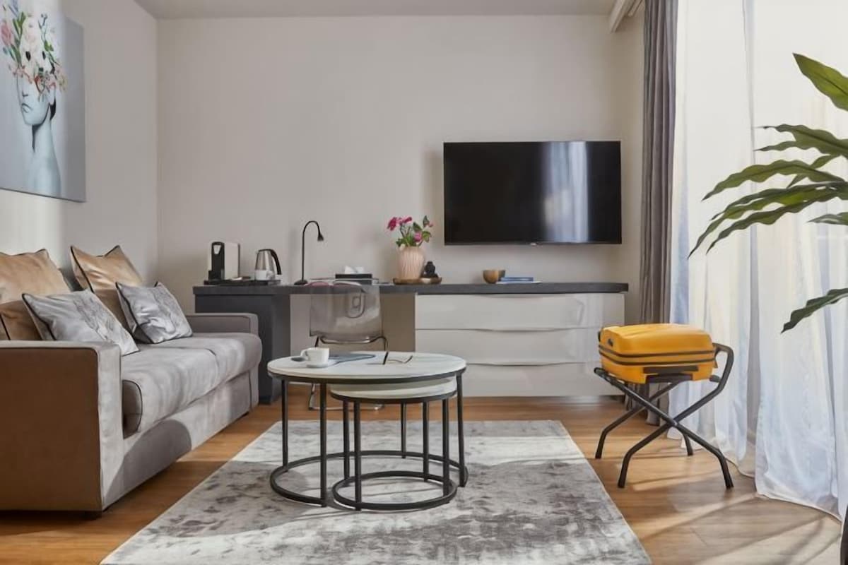 A modern living room with a sofa, coffee table, and a television.