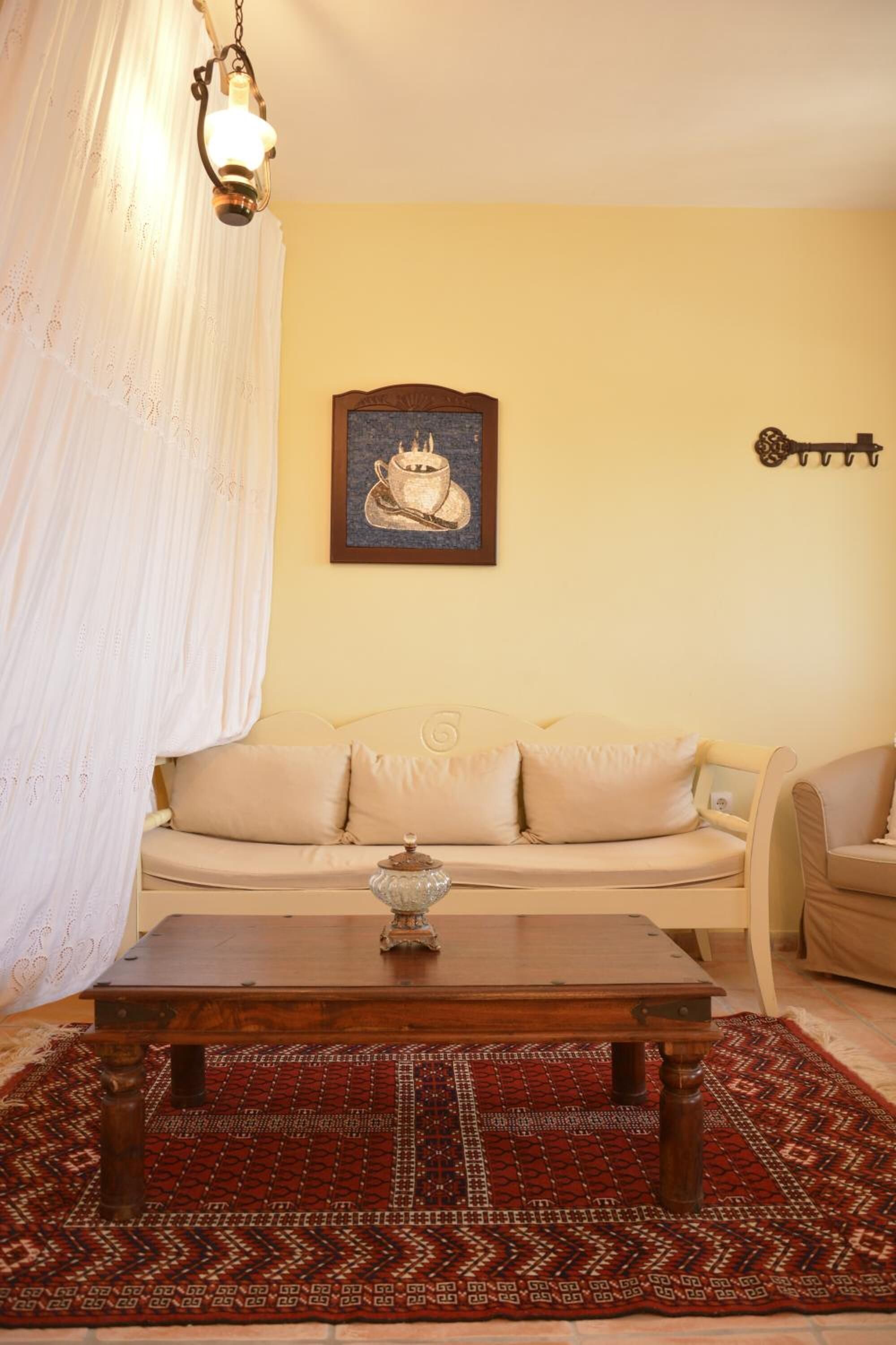 A cozy living room with a sofa, a coffee table, and a patterned rug.