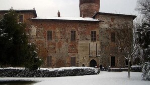 A historic building with a central tower and multiple windows.