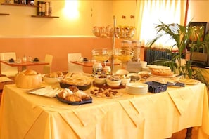Una mesa de buffet con diferentes alimentos y una estación de café.