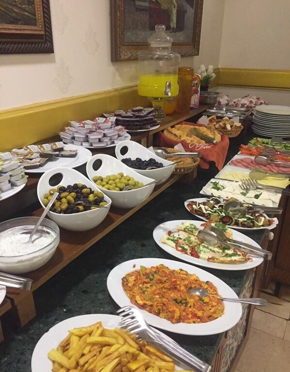 A buffet with various dishes including salads, meats, and desserts.