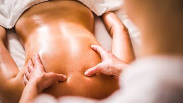 A close-up of a massage being performed on a person's back.
