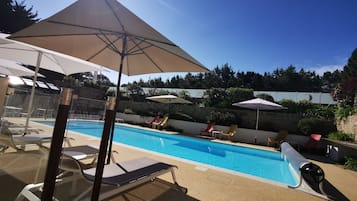 Piscine extérieure, parasols de plage, chaises longues