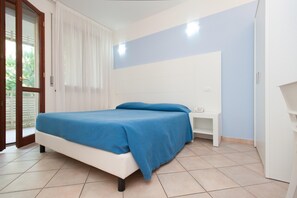 A bedroom with a bed, a nightstand, and a white wardrobe. - Antica Ravenna Residence (Ravenna)