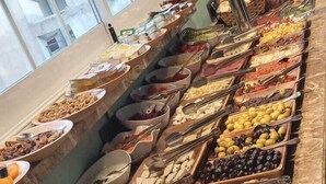 A buffet with various food items and condiments. - Triada Hotel Taksim (Istanbul)