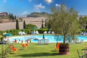Seasonal outdoor pool, open 7:30 AM to 7:30 PM, pool umbrellas