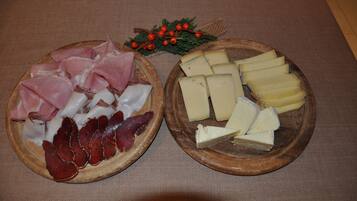 Two wooden platters with various meats and cheeses.