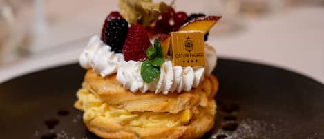 A dessert with whipped cream, berries, and a small sign on a plate.