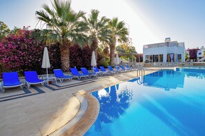 Seasonal outdoor pool, open 9:00 AM to 6:30 PM, pool umbrellas