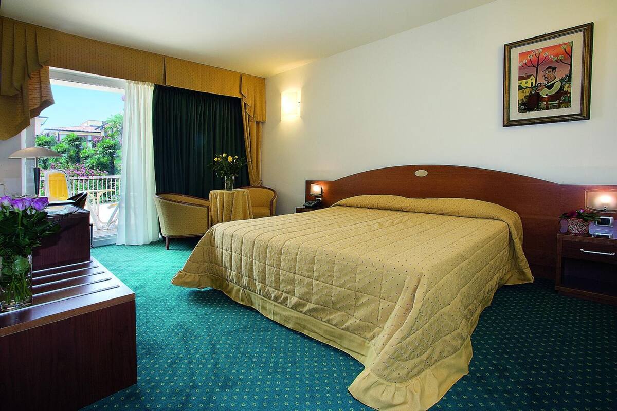 Suite, Balcony, Pool View | Minibar, in-room safe, desk, laptop workspace