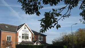 A two-story building with a sign reading "The Handforth Lodge." - The Handforth Lodge (Wilmslow)