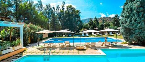 Seasonal outdoor pool, open 9:00 AM to 6:30 PM, pool umbrellas