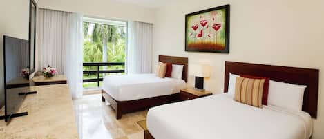A hotel room with two beds, a desk, a television, and a painting on the wall.