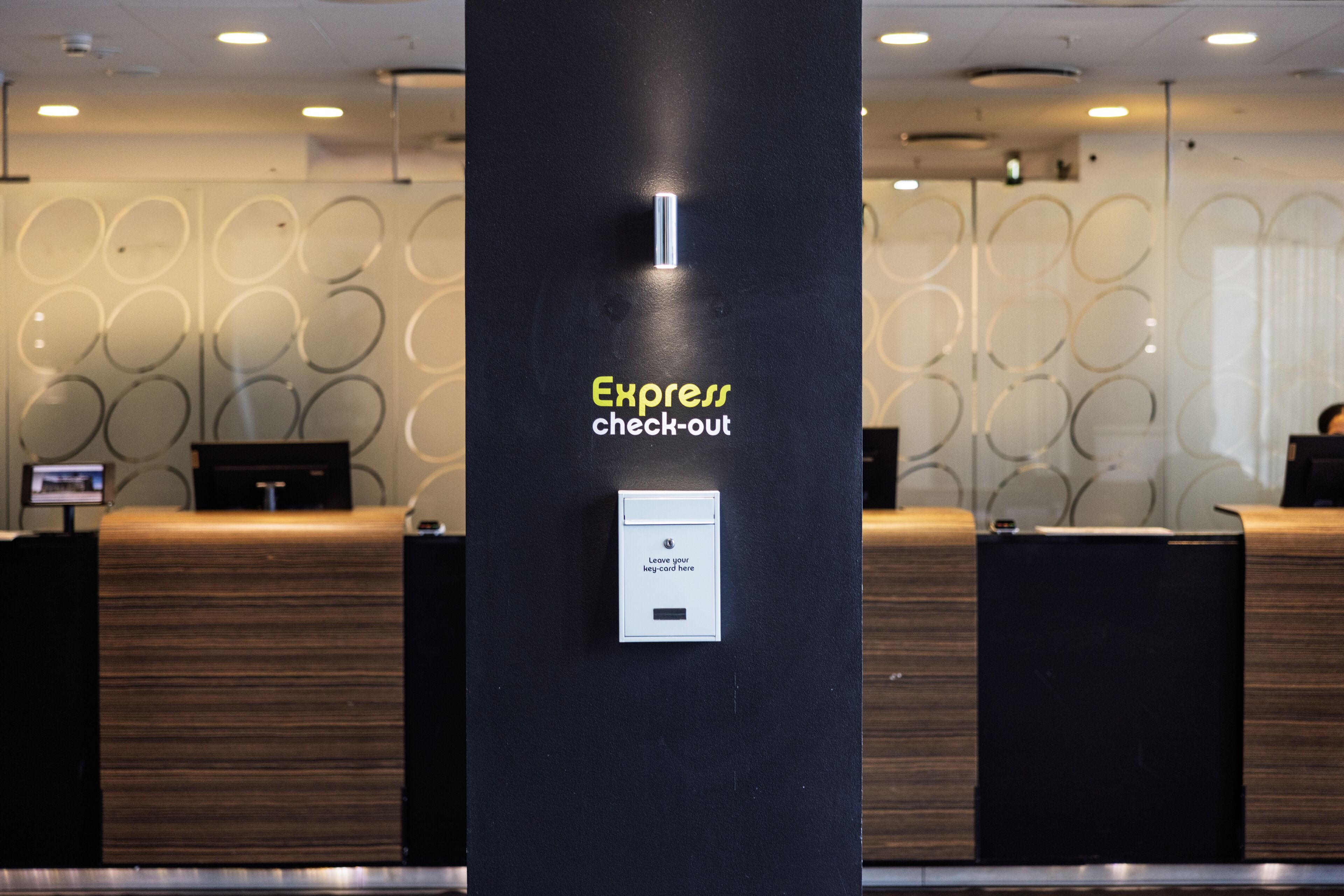 A check-out area with a sign indicating 'Express check-out' and a machine for leaving a leg card.