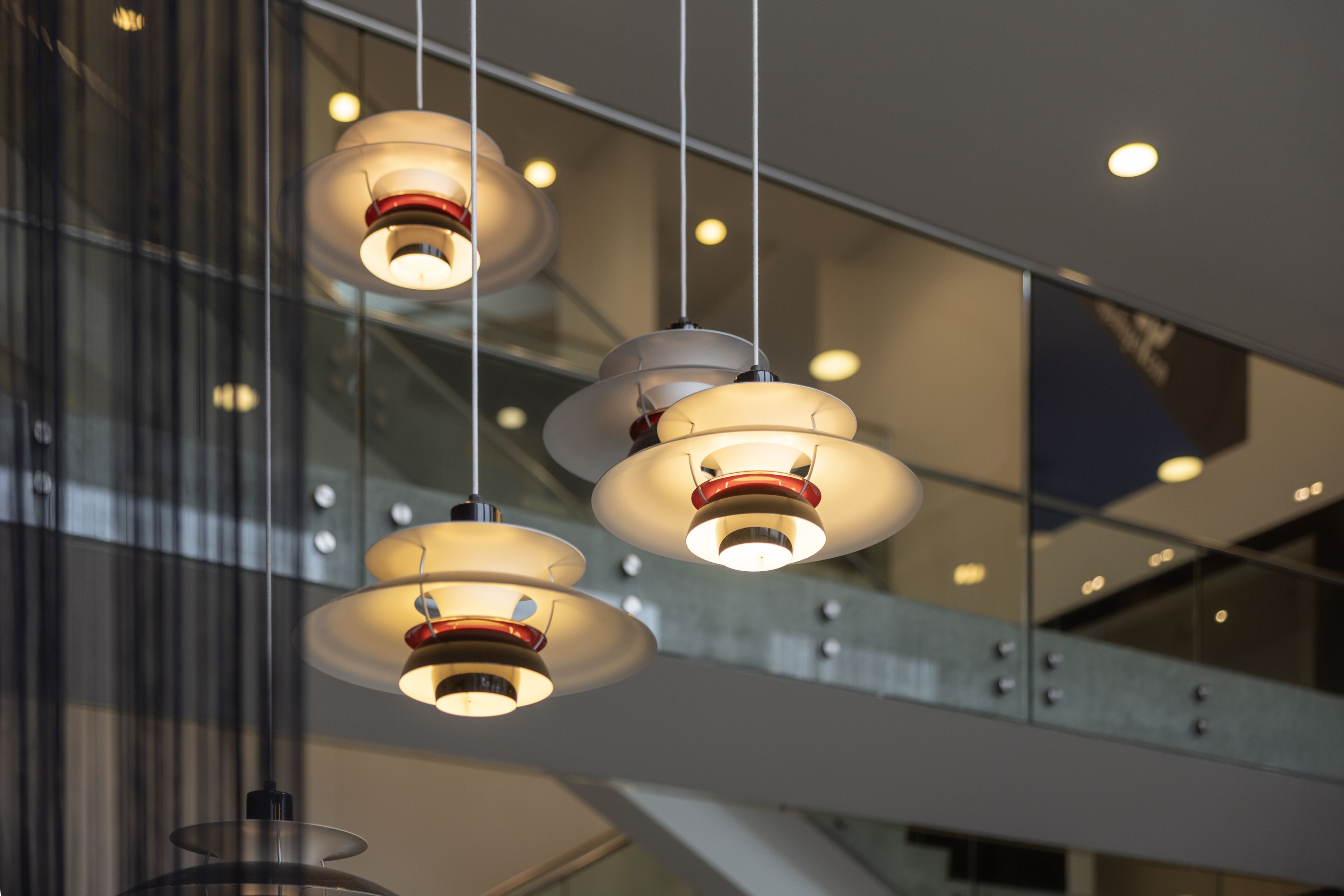 A modern interior with pendant lighting and a glass facade.