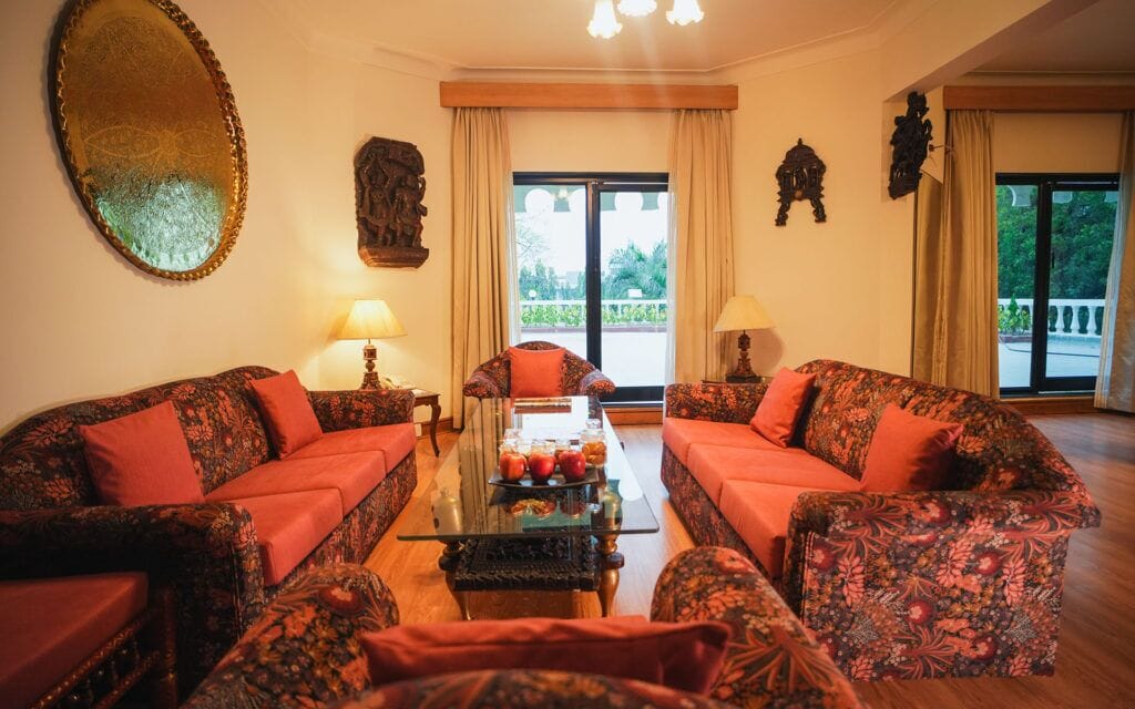 A living room with two sofas, a coffee table, and a large mirror.