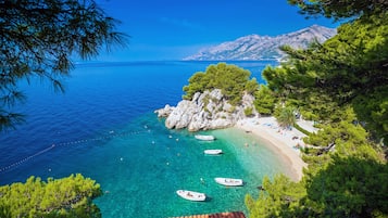 On the beach, sun loungers, beach umbrellas, scuba diving